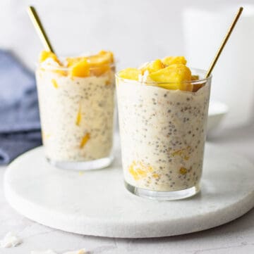 Two glasses of overnight oats with mango.