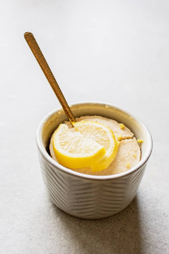 Lemon mug cake with a spoon.