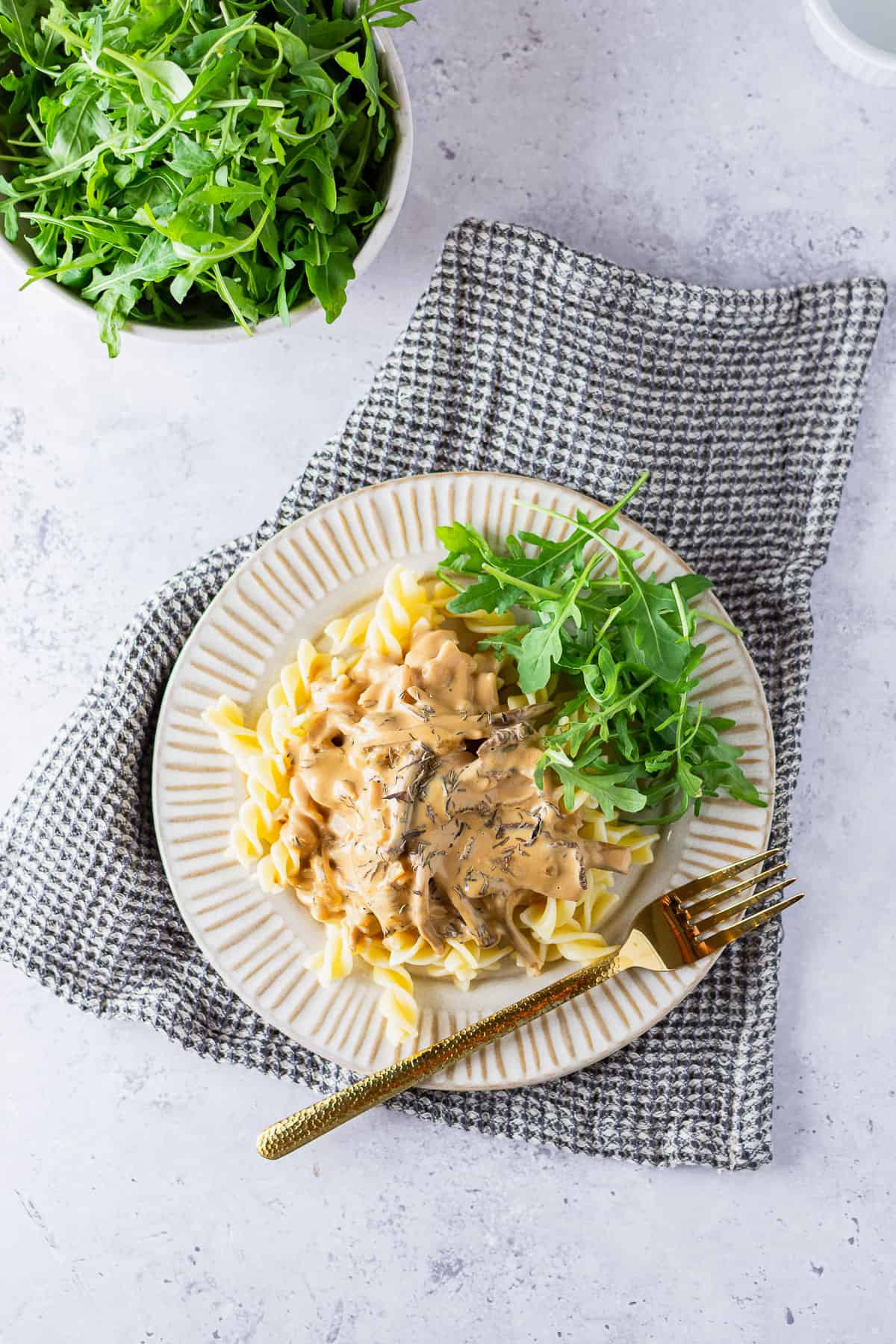 A flat lay of chanterelle mushroom sauce and pasta on a plate. 